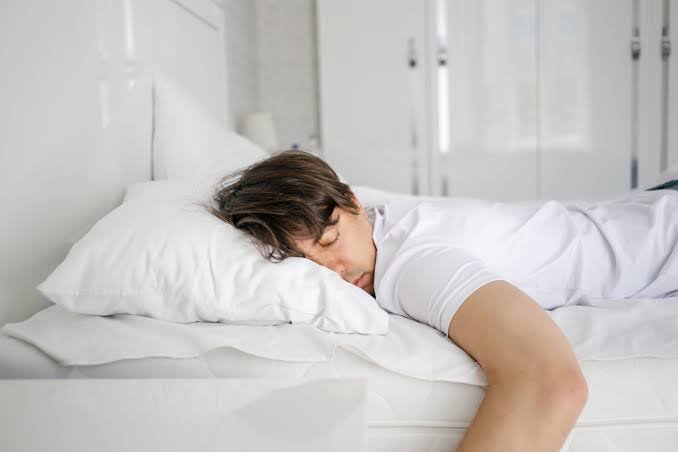 Person sleeping peacefully in a calm bedroom